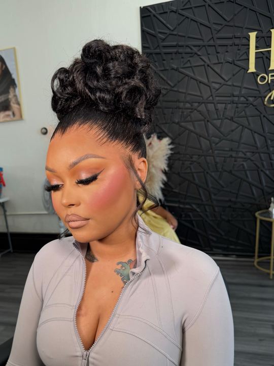 High sculpted curly updo with laid edges